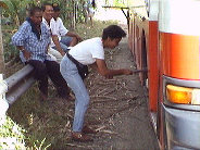 The female conducter changing the tyre.